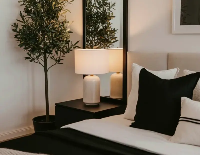 Minimalist bedroom makeover: before and after with olive tree & black accents